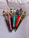 Seven beaded fun pens.